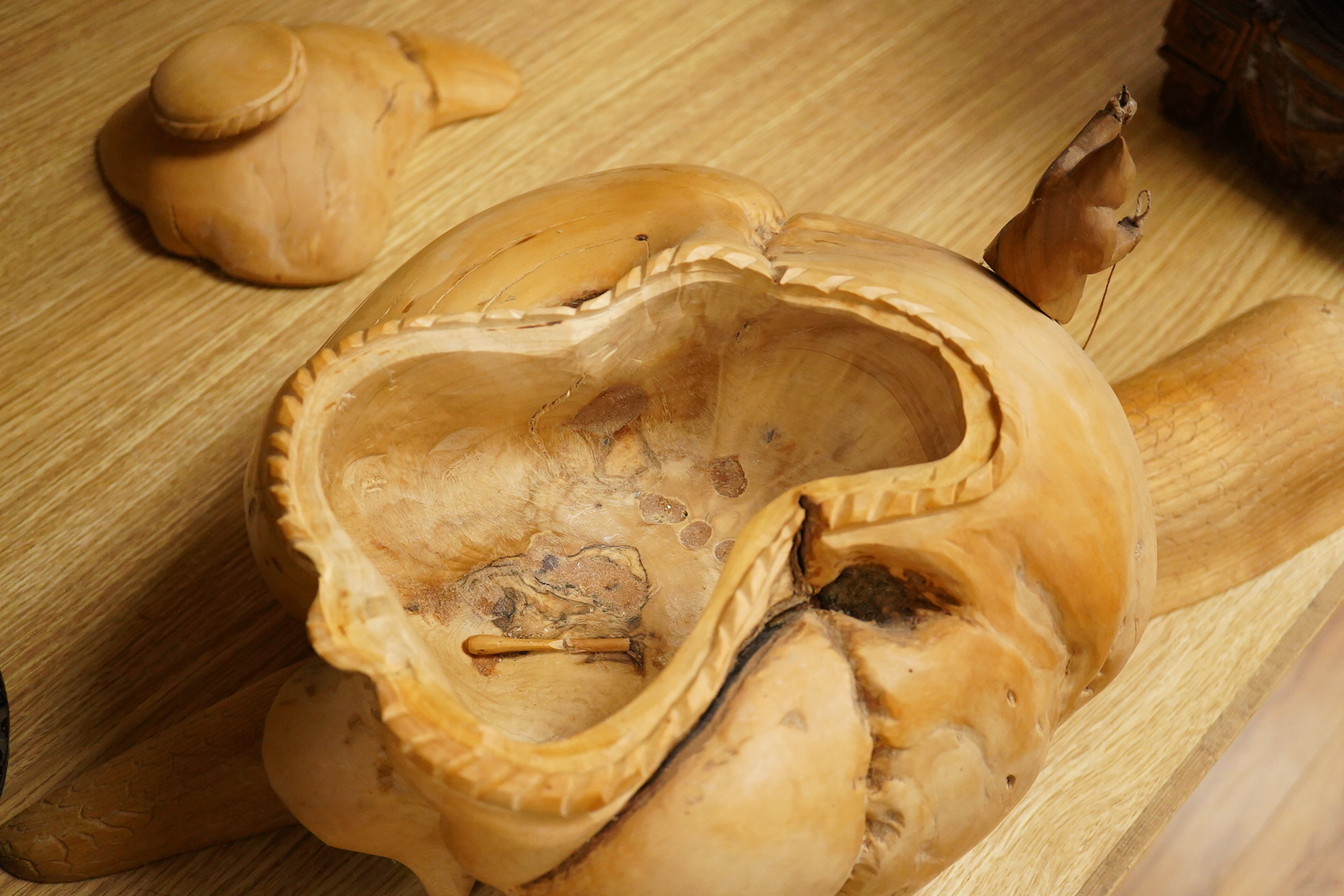 Pierre Decorse (b.1953), a naturalistically modelled wooden sculpture depicting a figure riding a snail, 53cm long